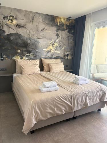 a bedroom with a large bed with two towels on it at Calypso Residence in Umag