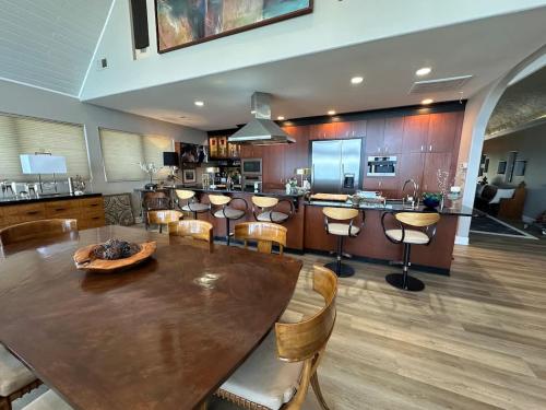 a large kitchen with a wooden table and chairs at Driftwood Dreams in Chapin