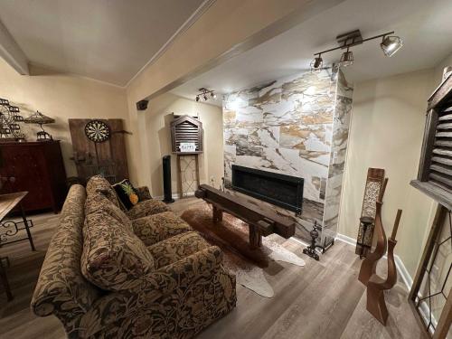 a living room with a couch and a piano at Driftwood Dreams in Chapin