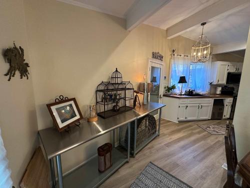 a kitchen with a table with a bird cage on it at Driftwood Dreams in Chapin