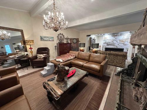 a living room with a couch and a table at Driftwood Dreams in Chapin