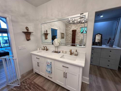 a bathroom with a sink and a large mirror at Driftwood Dreams in Chapin