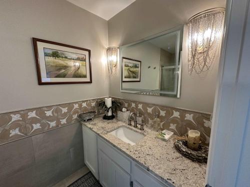 a bathroom with a sink and a mirror at Driftwood Dreams in Chapin