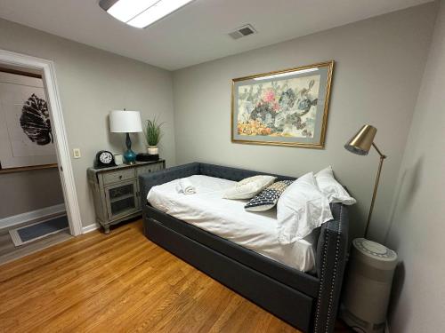 a bedroom with a bed and a painting on the wall at Driftwood Dreams in Chapin