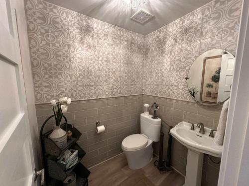 a bathroom with a toilet and a sink at Driftwood Dreams in Chapin