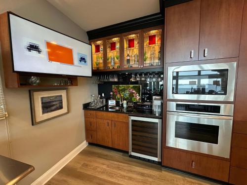 a kitchen with a bar with a sink and an oven at Driftwood Dreams in Chapin
