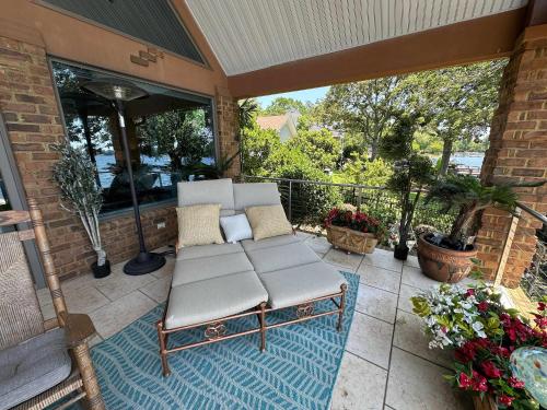 a porch with a couch on a patio at Driftwood Dreams in Chapin