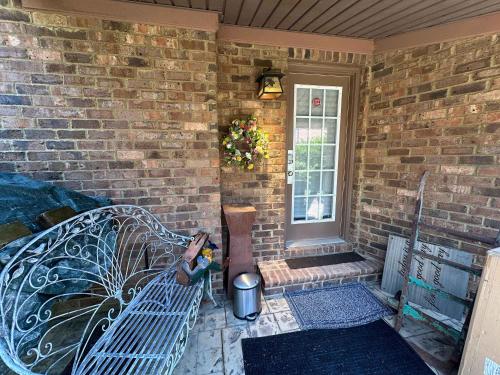 a brick house with a bench and a window at Driftwood Dreams in Chapin