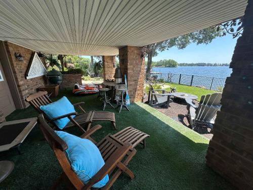 a patio with chairs and a view of the water at Driftwood Dreams in Chapin