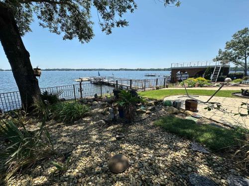 a garden with a tree and a body of water at Driftwood Dreams in Chapin