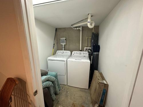 a small laundry room with a washer and dryer at Driftwood Dreams in Chapin