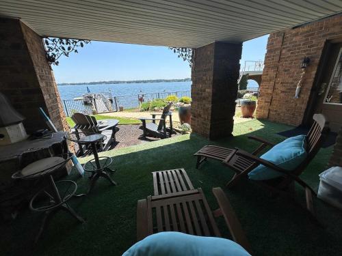 a patio with chairs and a view of the water at Driftwood Dreams in Chapin