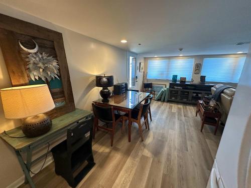 a living room with a table and a dining room at Driftwood Dreams in Chapin