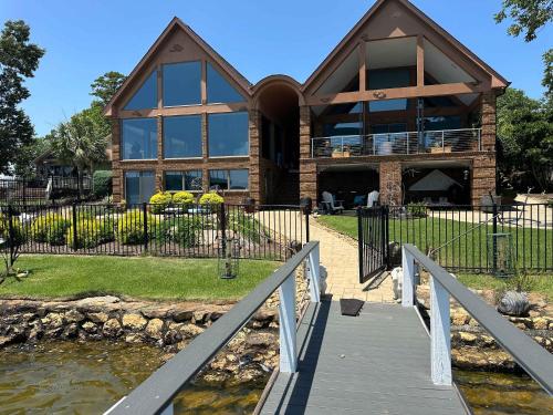a house with a wooden bridge in front of it at Driftwood Dreams in Chapin