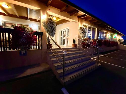 a house with stairs and potted plants at night at Gostisce Golob in Zgornja Polskava