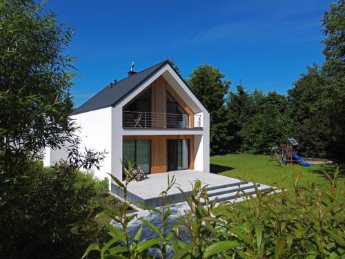 a small white house with a roof at Odpoczynek na wsi 