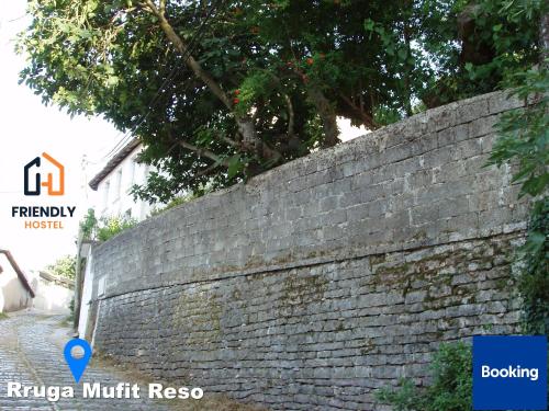 a brick wall in front of a building at Friendly Hostel in Gjirokastër