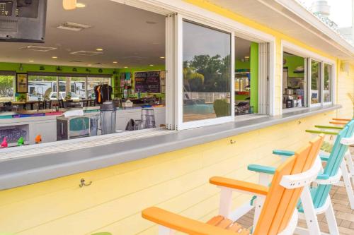 a restaurant with rocking chairs in front of a store at Ocean Grove RV Resort St Augustine in Saint Augustine