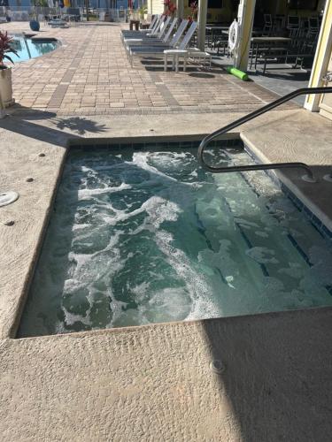 a pool of water with a hose on the ground at Ocean Grove RV Resort St Augustine in Saint Augustine
