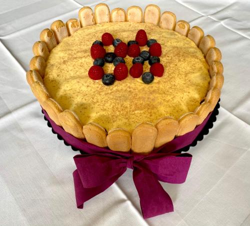 a cake with berries on top of it on a table at Gostisce Golob in Zgornja Polskava