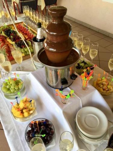 a table with a buffet of food and wine glasses at Gostisce Golob in Zgornja Polskava