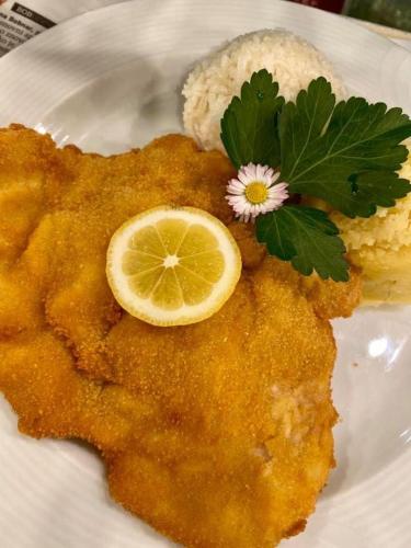 a plate of food with a slice of lemon and rice at Gostisce Golob in Zgornja Polskava