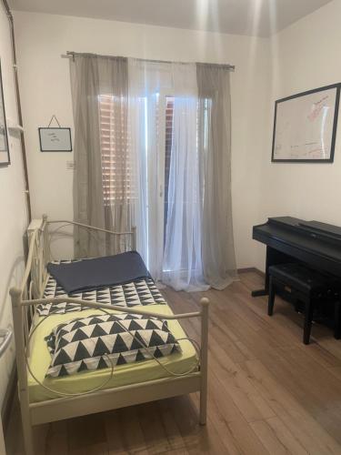 a bedroom with a bed and a piano at Chill house in Makarska