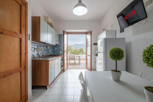 a kitchen with a table with a plant on it at Design Villetta by Propertize in Villasimius