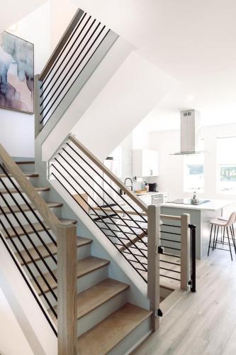 a staircase in a house with a kitchen and a dining room at ModTrio 3BR with ensuites & Garage Mins to Uptown in Charlotte
