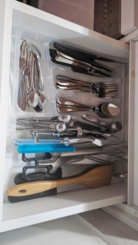 a drawer full of utensils in a kitchen at Emari - Hochwertige 2-Zimmer-Wohnung mit Panorama Bergblick in SJJ