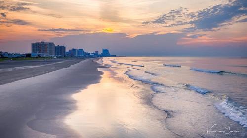 a view of a beach with a city in the background at Ammos Luxury Living- Milos Suite in Ventnor City