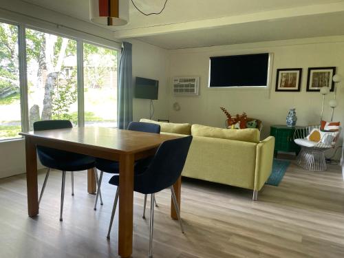 a living room with a table and a couch at Colonial Bay Motel and Cottages in Huntsville
