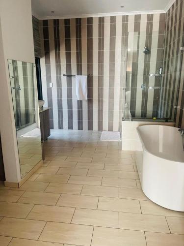 a large bathroom with a tub and a shower at Tan Ridge Hill in Vosburg