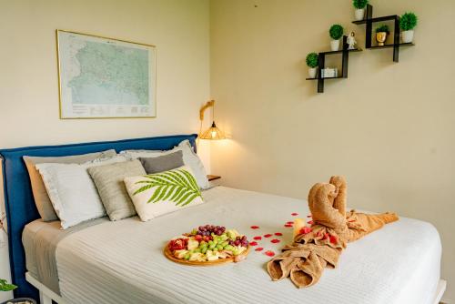 a bed with a plate of food on it at Casa Ejecutiva Boquete in Boquete