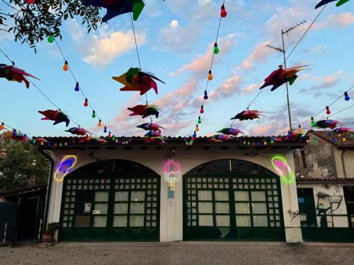 a building with a bunch of kites hanging above it at B&B La Borasca - Rooms in Casalpusterlengo