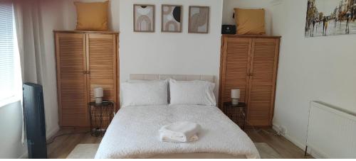 a bedroom with a bed with a towel on it at Brits-Halley Luxury Apartments in Annfield Plain