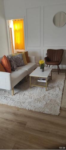 a living room with a couch and a coffee table at Brits-Halley Luxury Apartments in Annfield Plain