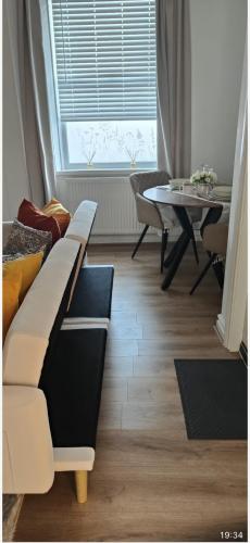 a living room with a couch and a table at Brits-Halley Luxury Apartments in Annfield Plain