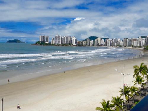 a view of a beach with buildings and the ocean at Tombo Beach in Guarujá