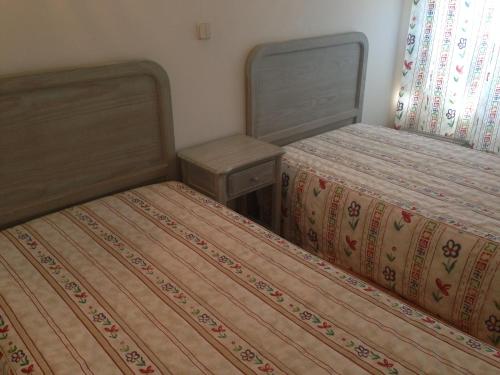 two beds sitting next to each other in a room at Soltejo in Vila Nova da Barquinha