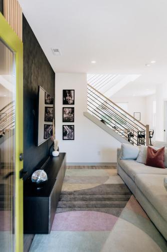 a living room with a couch and a staircase at ModTrio 3BR with ensuites & Garage Mins to Uptown in Charlotte