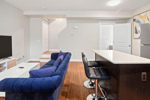 a living room with a blue couch and a counter at Affordable 2-BR Heart of Detroit in Detroit