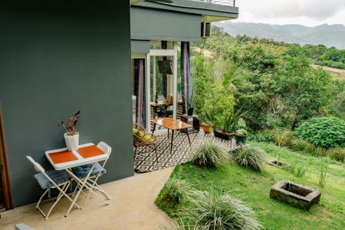 a house with a balcony with a table and chairs at Casa Ejecutiva Boquete in Boquete