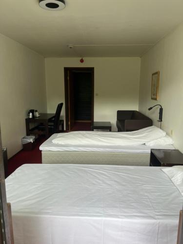 Ένα ή περισσότερα κρεβάτια σε δωμάτιο στο Elvehagen Hotell