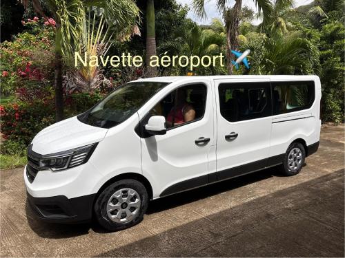a white van parked in front of a resort at Le Paradis de la Guadeloupe in Pointe-Noire