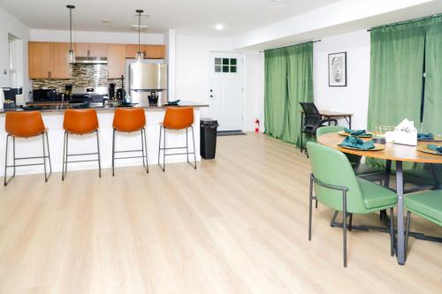 a kitchen and dining room with a table and chairs at Modern Minimalist Lux Paradise in Newark