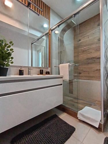 a bathroom with a glass shower and a sink at Holiday&Suite Klanac in Vir