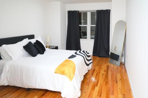 a bedroom with a bed and a surfboard next to a window at Modern Minimalist Lux Paradise in Newark