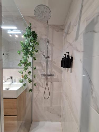 a bathroom with a shower with a plant in it at La Karina in Denia