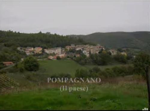 a field of green grass with a town in the distance at la casetta delle more (monolocale) in Spoleto